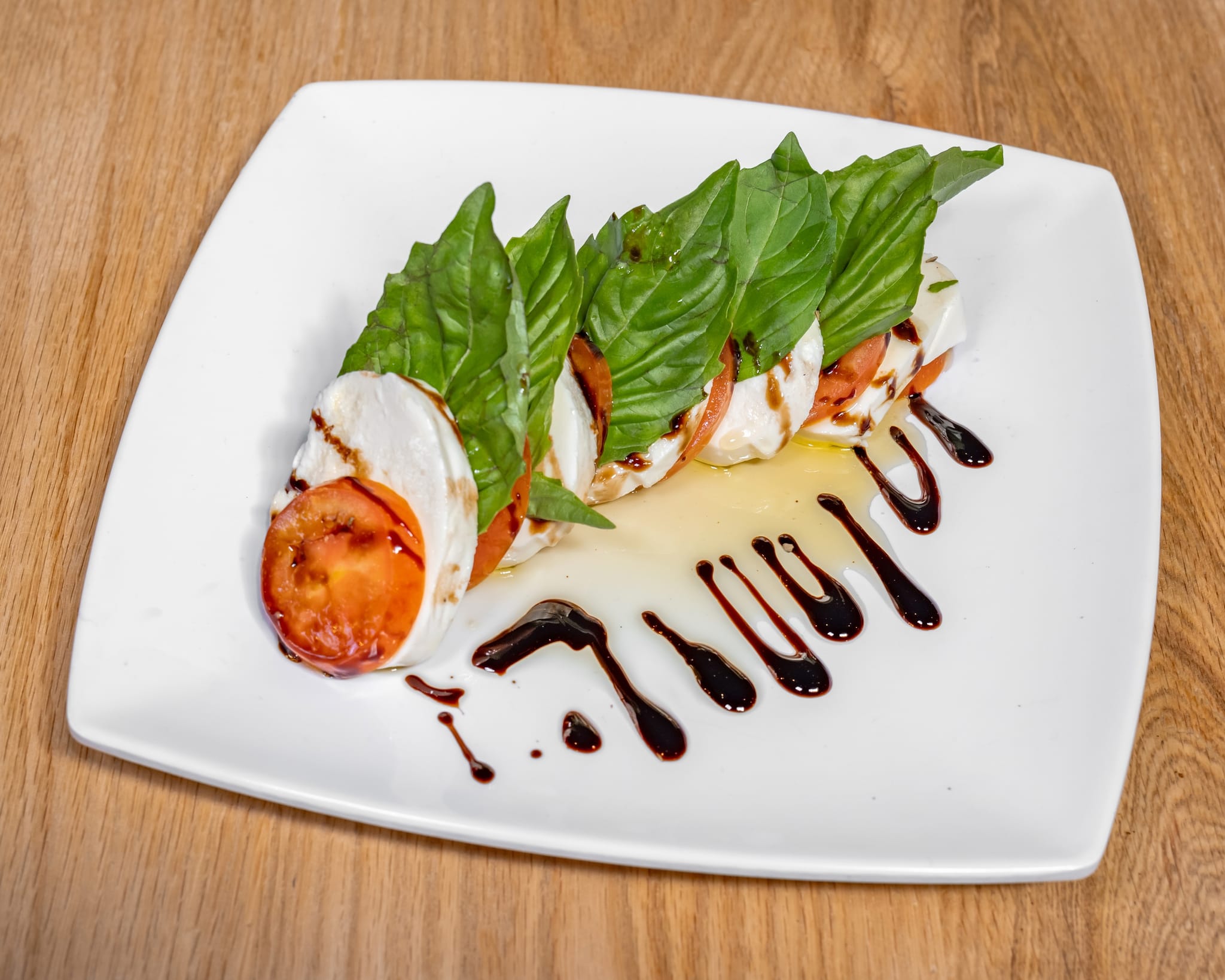 Mozzarella caprese — tomatoes and fresh mozzarella with basil and balsamic.