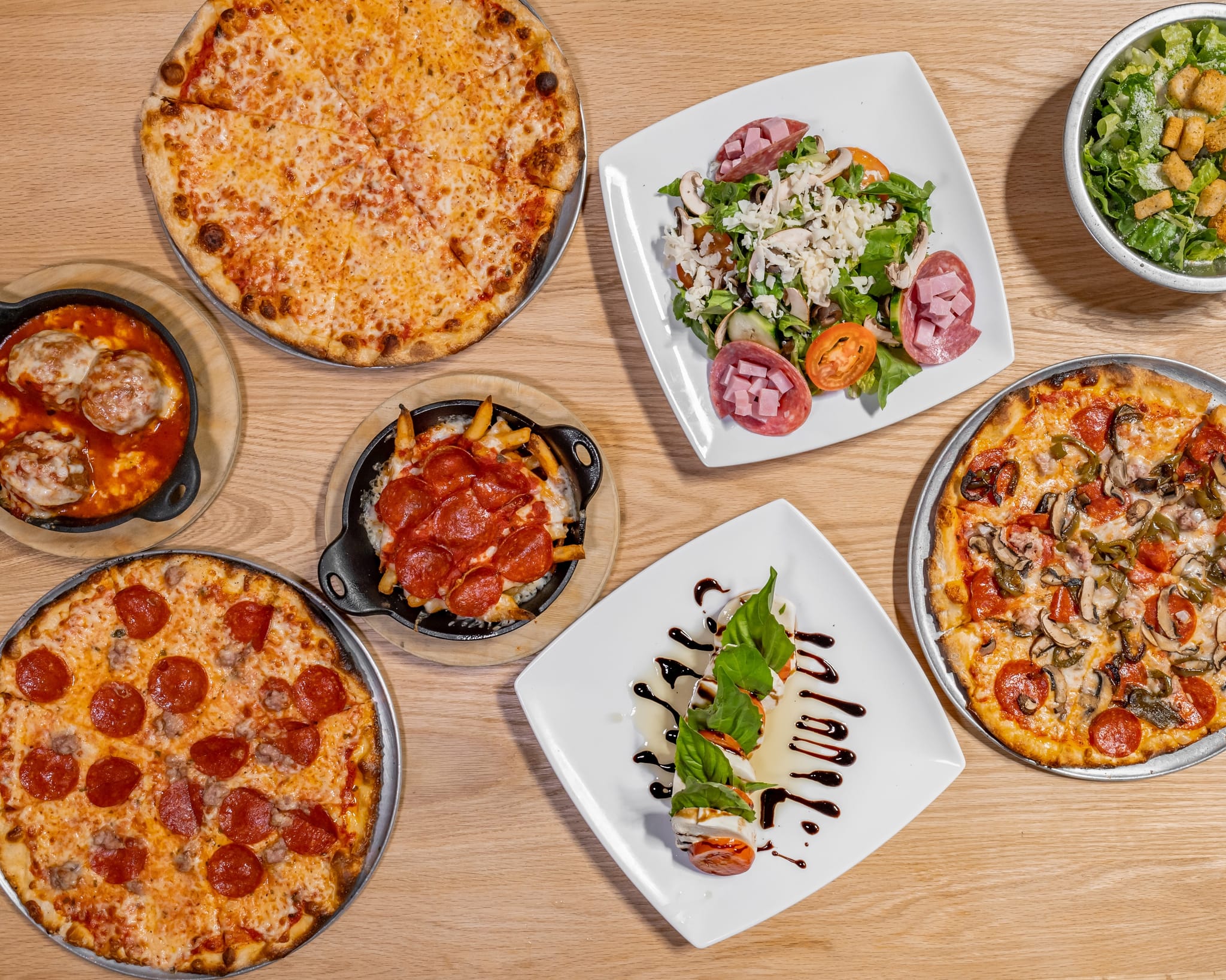 A spread of Good Side pizzas — foldable New York-style pies, fresh from the oven.