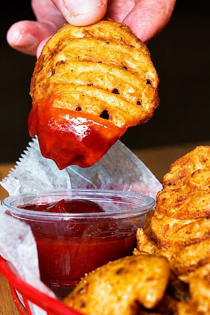 A waffle fry dipped in ketchup