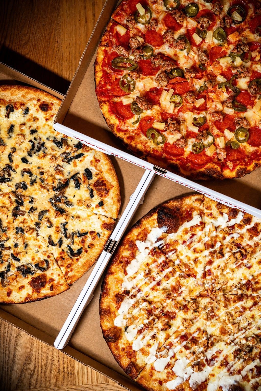 Three pies in open boxes, overhead