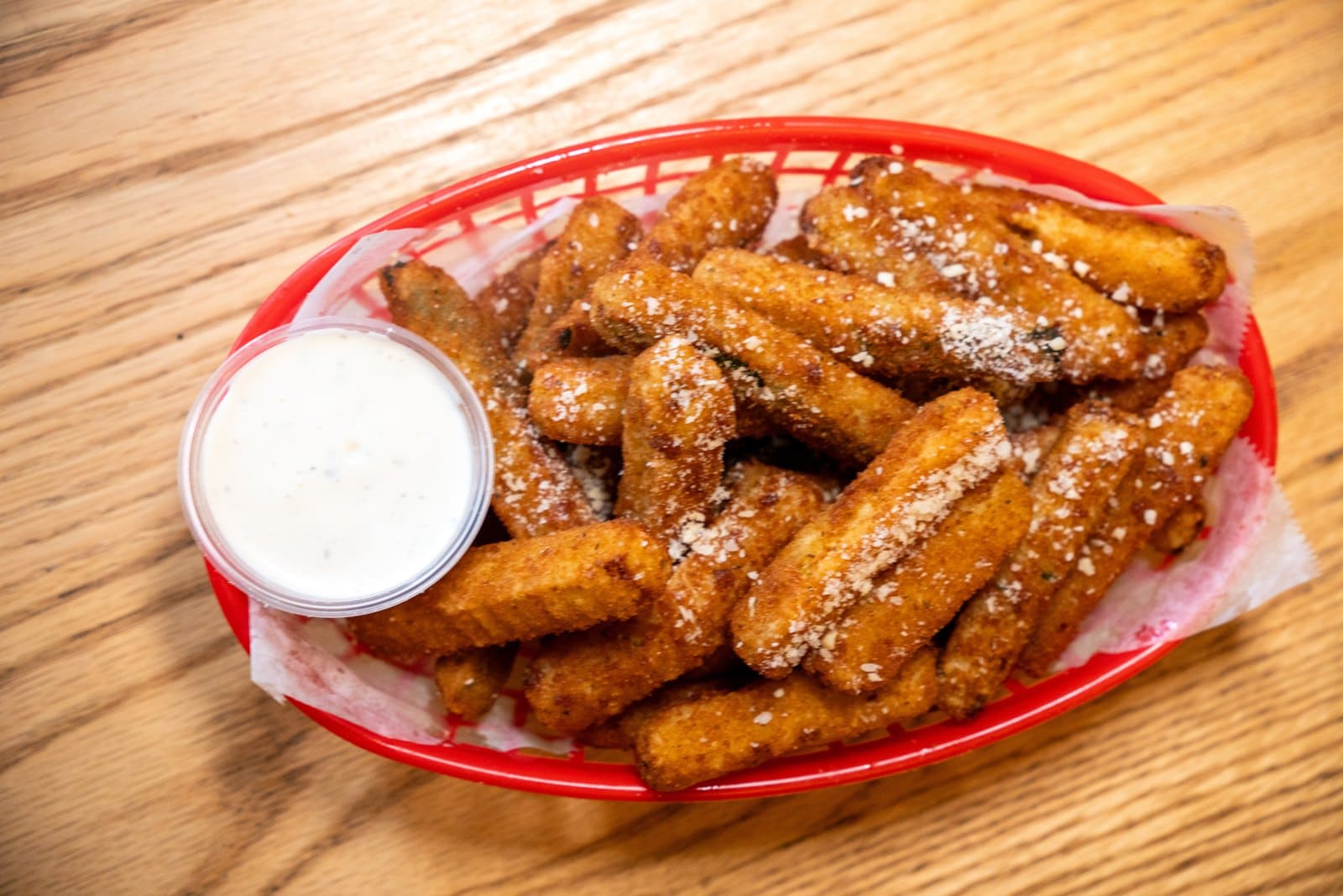 Fried cheese sticks with ranch in a basket